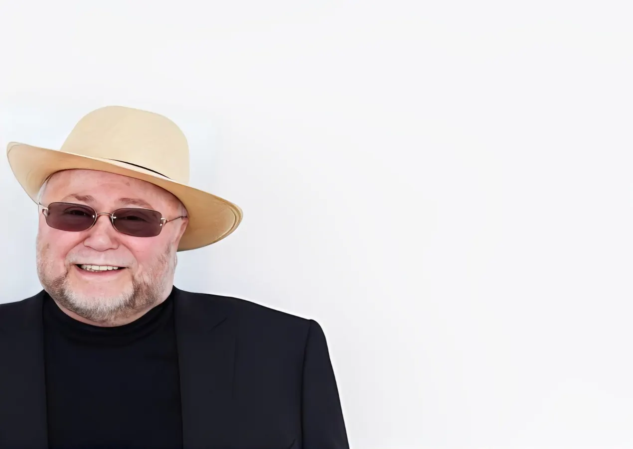 Portrait of children's author Leonard I. Eckhaus in a fedora and sunglasses